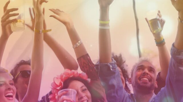 Cheering friends raising plastic cups at festival, showing floral crown as responding to beat drop