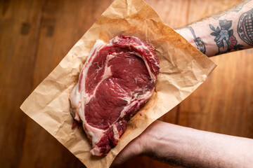 Fresh marbled steak on paper.
