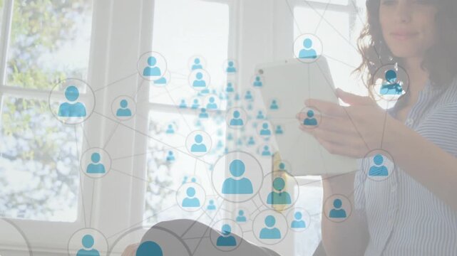 Woman bringing tablet up, tapping and scrolling while network icons expanding, showing tech links