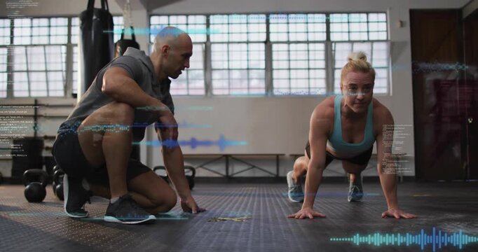 Vertical video: Trainer cueing, trainee pressing up into plank on mat, fitness waves tracking form