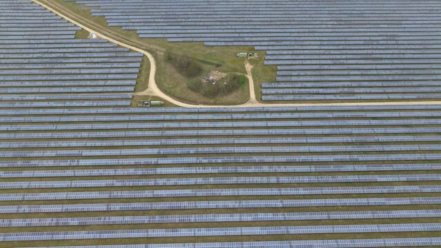 Aerial view of endless rows of solar panels stretching into the horizon near the former RAF Alconbury, Huntingdon, Cambridgeshire, United Kingdom.