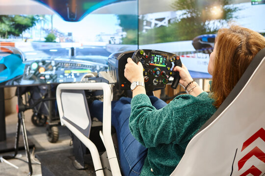 Race driving simulator console player. Video game control and perfomance.