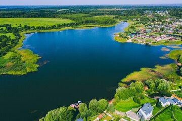 Aerial View of Lush Green Landscape with Calm Waters and Residential Areas Surrounding a Lake