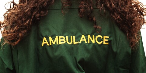 Back view of a person with curly hair wearing a green jacket with 'AMBULANCE' in yellow. Ambulance jacket, curly hair, green uniform, emergency services. Healthcare concept. © Rawpixel.com