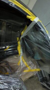 Vehicle Undercarriage Parts Secured And Protected For Maintenance Work, Underbody Area Has Masking Materials Applied And Components Are Ready For Corrosion Prevention Procedures In Service Area