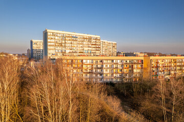 Fototapeta premium Aerial view of residential apartment blocks in a post-communist district during golden hour sunset