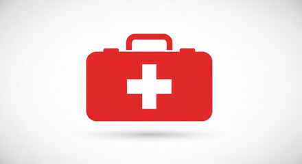 Obraz premium Red medical first aid kit box with white cross on lid handle and subtle shadow on clean background