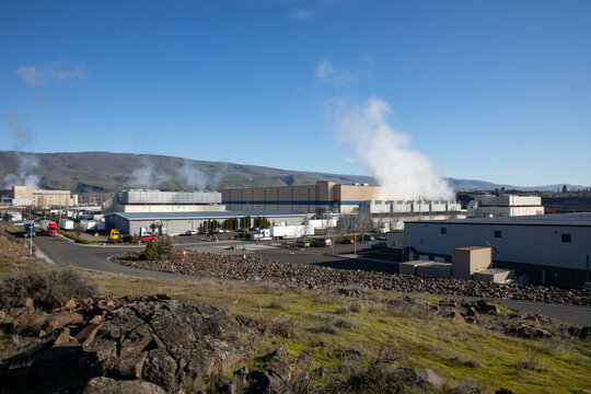 The Dalles, Oregon, USA - Mar 2, 2026 - Google data center campus with cooling steam rising from industrial server buildings supporting cloud computing and artificial intelligence infrastructure.