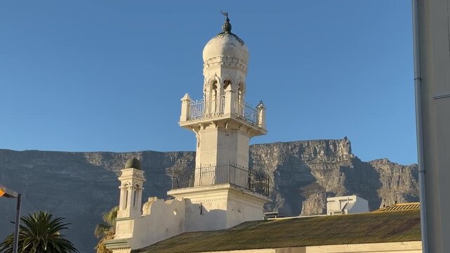 An old Mosque built in the 1800s in Cape Town with Table Mountain in the background.