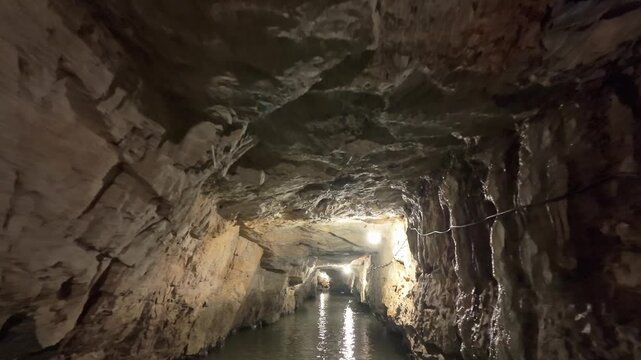 A view of the underground river in Trang An, Ninh Binh, Vietnam. Tourists visit to experience the natural wonder.