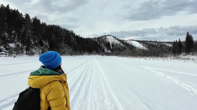 Caucasian Female Enjoying Winter Nature Scenery. Woman In Winter Gear Capturing Selfie Amid Mountain Landscape. Caucasian Woman Dressed For Snow Capturing Moment With Skis And Scenery In Background