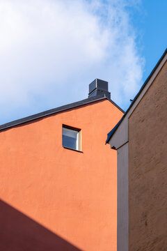 Geometric gable wall in sunlight and shadow with blue sky in Stockholm Sodermalm Sweden showcasing minimalism architecture