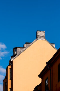 Clean minimalism gable roof and facade in sunlight against sky in Stockholm Sodermalm Sweden showcasing architecture