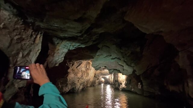 A view of the underground river in Trang An, Ninh Binh, Vietnam. Tourists visit to experience the natural wonder.