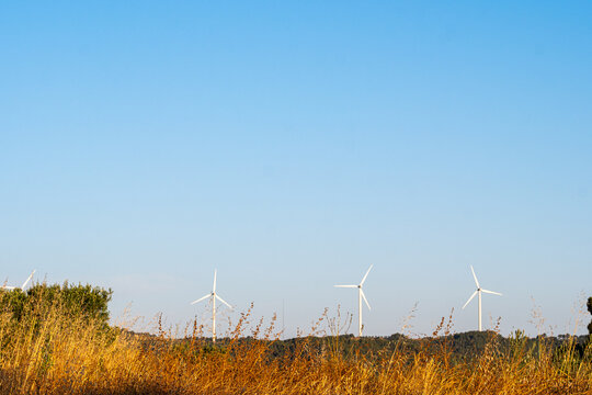 Renewable energy wind turbines against open sky above landscape in Terra Alta Catalonia Spain with modern clean power scene and wide space