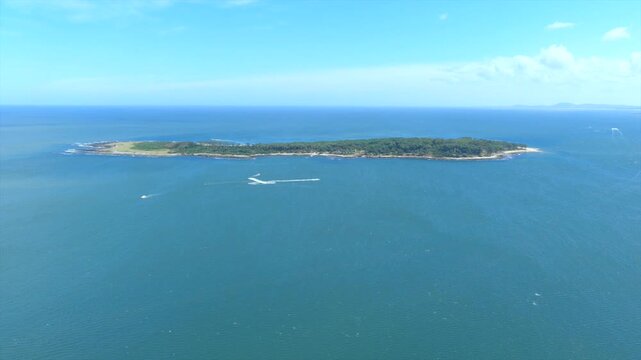 Aerial view of Isla de Gorriti island, a jewel amidst the azure sea, with boats leaving trails on the water, Punta del Este, Departamento de Maldonado, Uruguay.