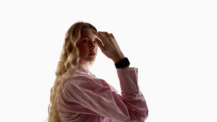 Young woman wearing smartwatch on wrist isolated on white background. Concept of wearable device promotion, gadget advertising, mobile technology marketing and smart electronics.