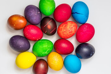 Easter eggs painted in different colors, on a white background, top view