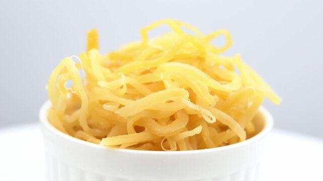 Beer snack made of dried squid. Dried squid isolated on white background. Dried squid shavings. Small fish, shrimp and squid that have been marinated with salt and dried