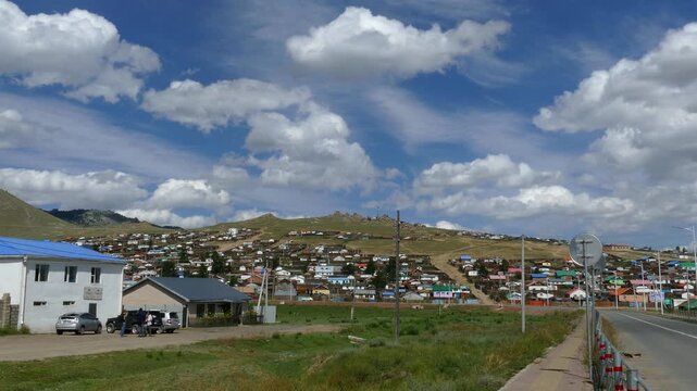 Tsetserleg, Mongolia - 18 july 2017: The small Mongolian town of Tsetserleg. Hills under a picturesque cloudy sky. Mongolian cityscape. Summer hot and sunny day.