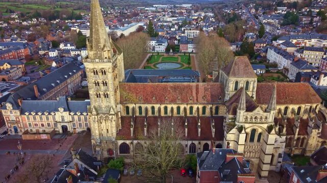 Saint-Pierre Cathedral and the formal Bishop's Garden, overlooking the city of Lisieux in Normandy, France. Aerial backward tilt-up reveal