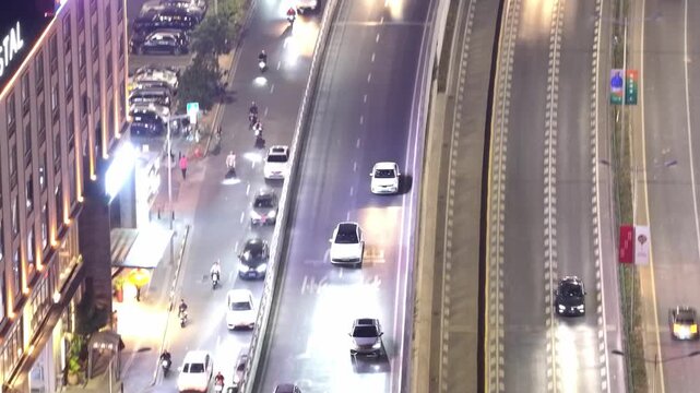 Aerial drone top night view of modern cityscape with car ride multi level road on highway overpass, urban life. Chinese multilevel interchange junction. Roadway traffic in China. Follow expressway.