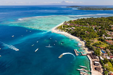Scenic Gili Air tropical island beach, pier, and coral reef viewed from above