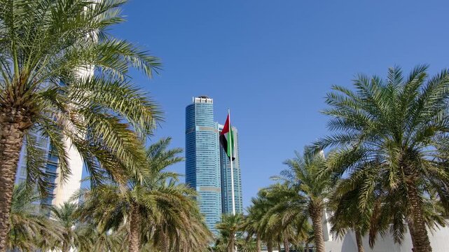 Bright daylight reveals Etihad Towers rising over Abu Dhabi, clean lines reflecting sun, modern silhouette shaping strong city mood, clear sky framing powerful architecture in calm summer air.