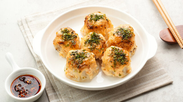 Dimsum with Japanese Mentai Sauce. Served on plate.