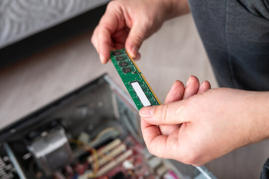Person installing ram in desktop computer for hardware upgrade