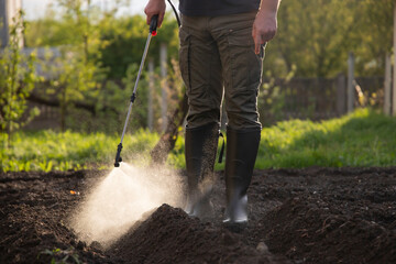 Farmer spraying fertilizer.  Pest control and plant diseases to obtain a large harvest