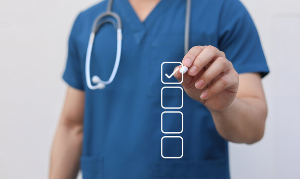 close up young general practitioner hand use stylus pen to check box on medical checklist or opd record to read and diagnose and assess about patient's symptom for healthy and lifestyle concept