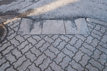 Sidewalk curb transition with residual winter gravel