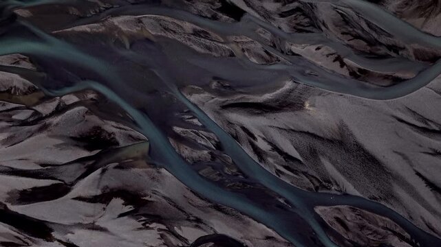 Aerial view of braided rivers weaving through the landscape, creating a mesmerizing display of nature's artistry, Rangarthing eystra, Iceland.
