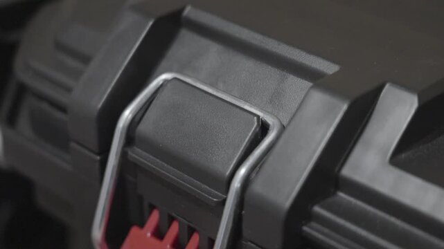 Slow motion look at opening the hinge on a tool box.