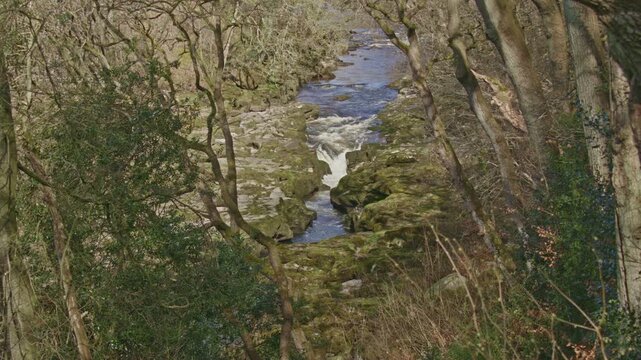 fast flowing river entering the strip in North Yorkshire. 25fps, 4k