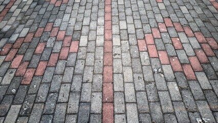 Fototapeta premium Pavement Pattern Brick Walkway Texture Outdoor Urban Design High Angle View Stone Path Background Ground Construction Surface with Geometric Red and Gray Block Paving and Perspective Backdrop