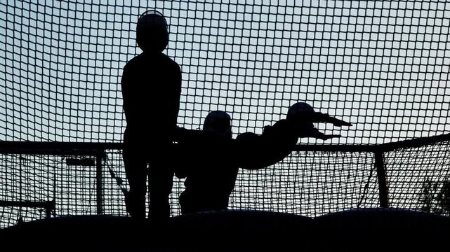 People taking indoor skydiving lessons experiencing freefall in a wind tunnel