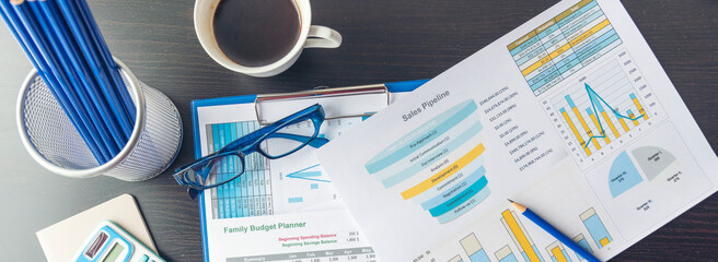 Banner Business Graphs charts office desk with copy space. Surfing internet online technology lifestyle. Banner Financial Planning Account Database Report. Technology lifestyle. Finance Excel graph