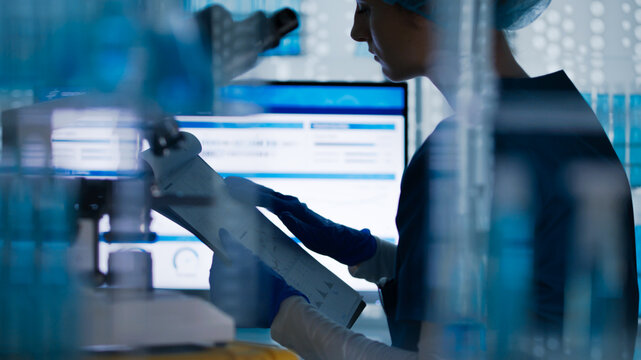 Research work in a medical lab. Two researchers discussing test results