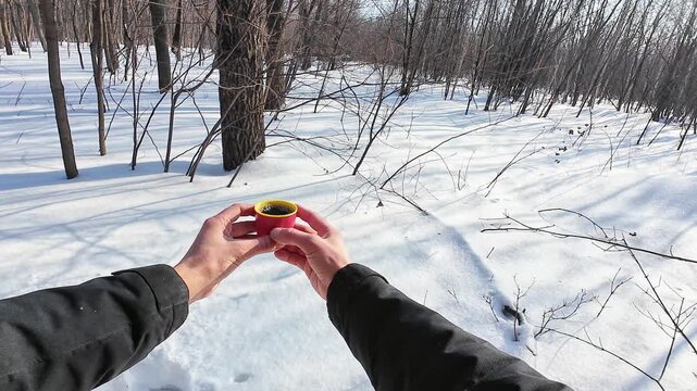 Man Outside Drinking. Person Pauses To Enjoy Warm Coffee Outdoors. Man Consumes Hot Beverage In Open Air Environment. An Individual Takes Moment To Savor Steaming Coffee Outdoors Amid Nature