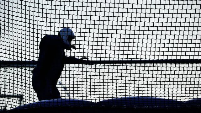 Skydiving simulator silhouette flying in a vertical wind tunnel during indoor training