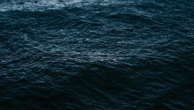 Rippling dark ocean surface showing textured small swells offshore, with subtle highlights
