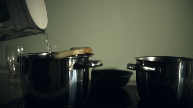 Stainless steel pots on a kitchen countertop.