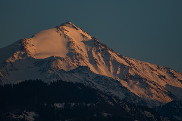 Dramatic Mountain Landscape with Fiery Sunset Light and Deep Shadows, Soviet Peak, Satpayev Peak,...
