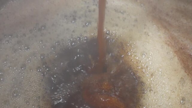 Hot soy sauce broth poured into pot