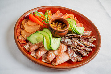 Delightful charcuterie platter featuring assorted meats and fresh vegetables served on a rustic plate