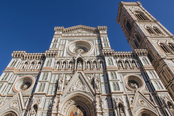 Fototapeta premium Duomo di Santa Maria del Fiore and Giotto's Bell Tower facade in Florence, Italy, admiring Renaissance architecture