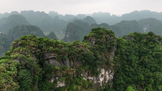 Aerial view of limestone karst peaks covered in lush jungle in ninh binh province, vietnam