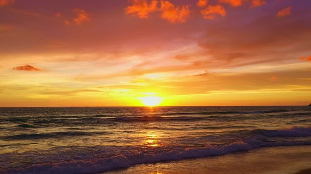 As the sun sinks below the horizon, the clouds ignite with radiant light, creating a dreamy, romantic glow over Karon Beach. A breathtaking sunset unfolds, where fiery skies meet serene waters